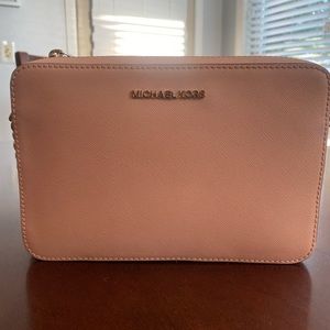 Michael Kors pink crossbody handbag.